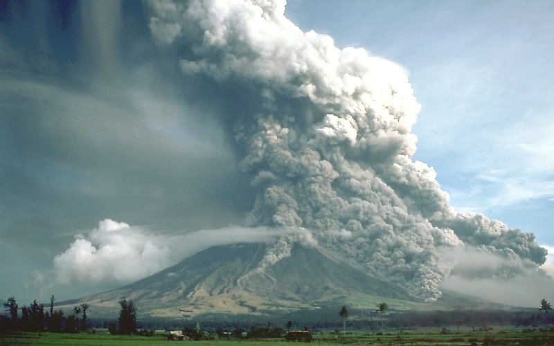 The Plinian eruption of Mt. Mayon, Philippines in 1984. Although most of the eruption column is ascending into the atmosphere, pyroclastic flows are traveling down the sides of the volcano in several places. Warnings were issued in time to evacuate 73,000 people.