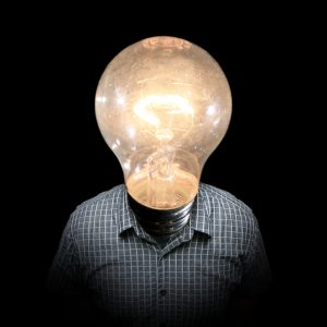 A person with a light bulb in place of a head.