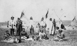 A Blackfoot tribe gathered in front of teepees.