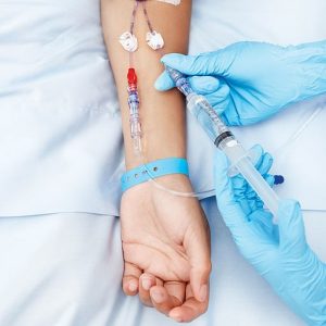 Close up of a patient arm fitted with an IV drip." title="Close up of a patient arm fitted with an IV drip.