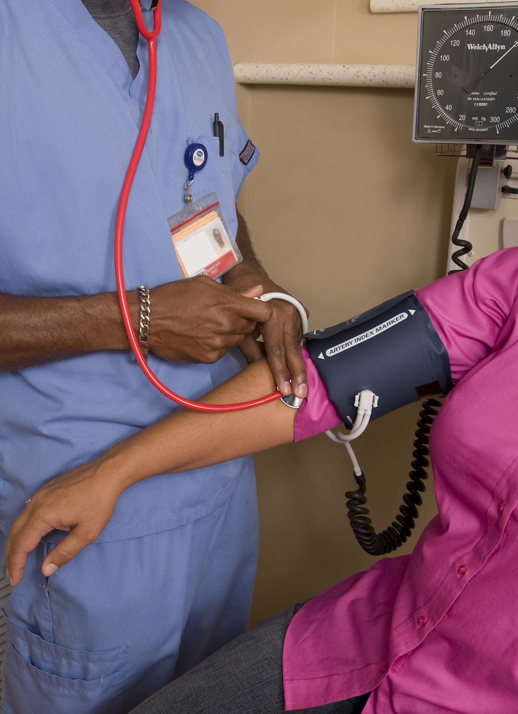 Nurse taking a person's blood pressure.